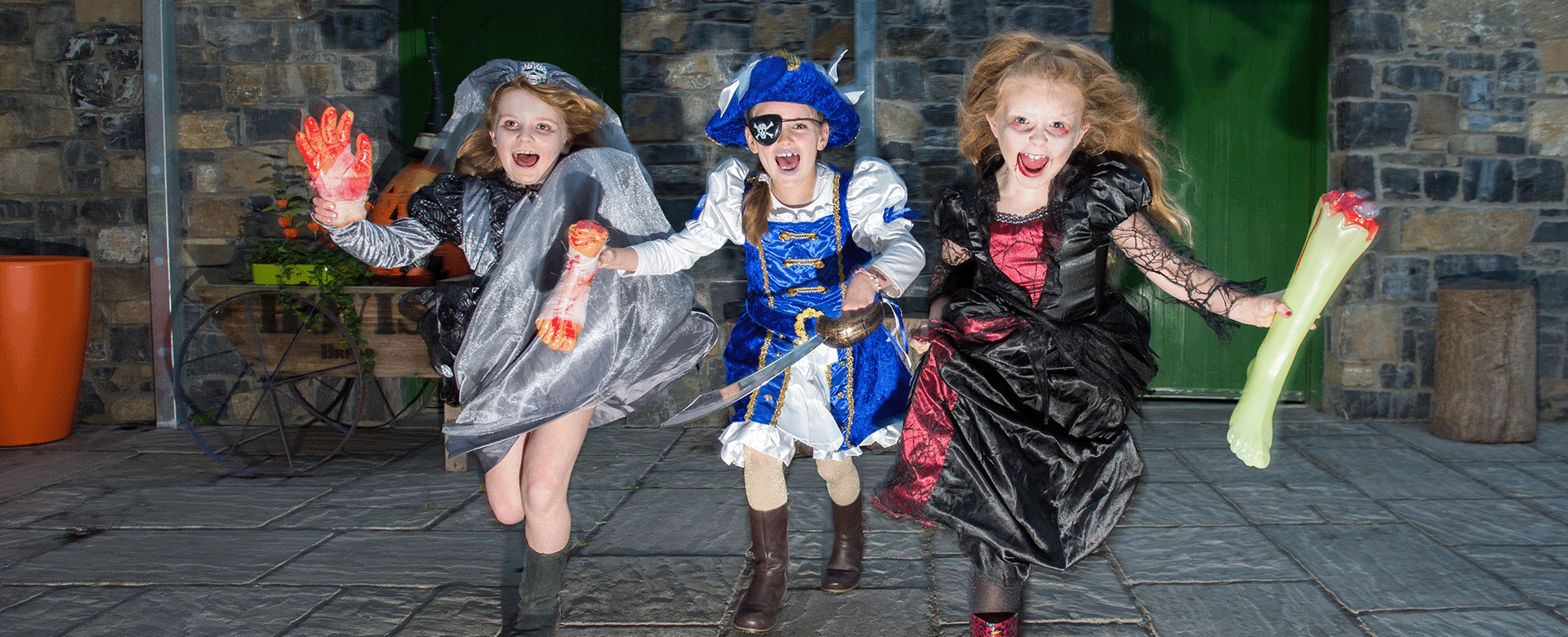 children dressed in halloween costumes holding severed limbs and screaming 
