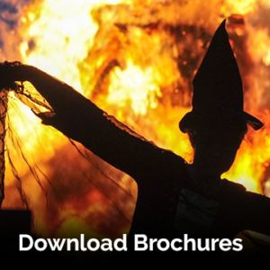 'Download Brochures' written on top of a photograph of a person in witch costume dancing in front of the flames of a fire